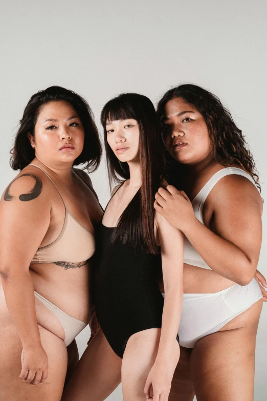 a group of three women standing next to each other, inspired by Ren Hang, unsplash, plus size woman, half asian, underwear ad, white skin color