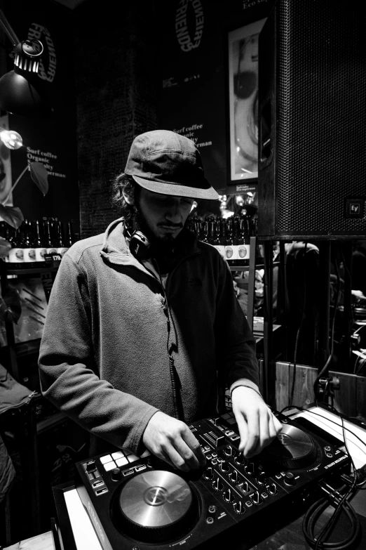 a man that is standing in front of a dj, by Felix-Kelly, monochrome, brass equipment and computers, profile picture 1024px, archwizzard in a hat