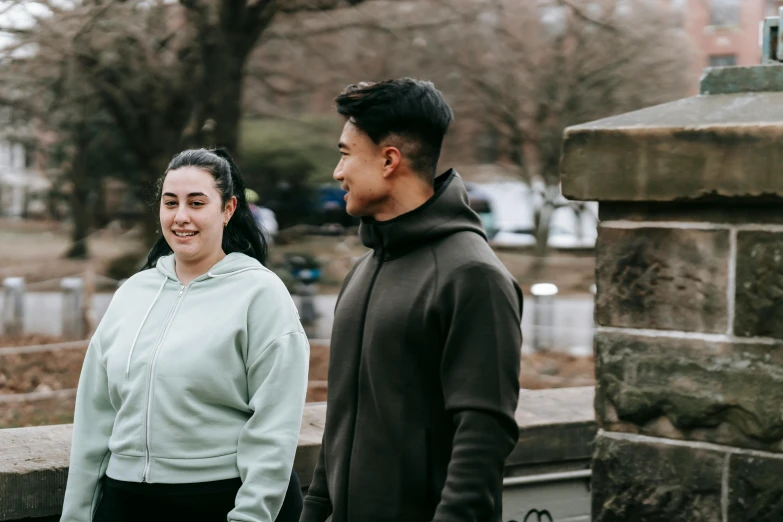 a man and a woman standing next to each other, pexels contest winner, happening, wearing a tracksuit, avatar image, sydney park, outdoor photo