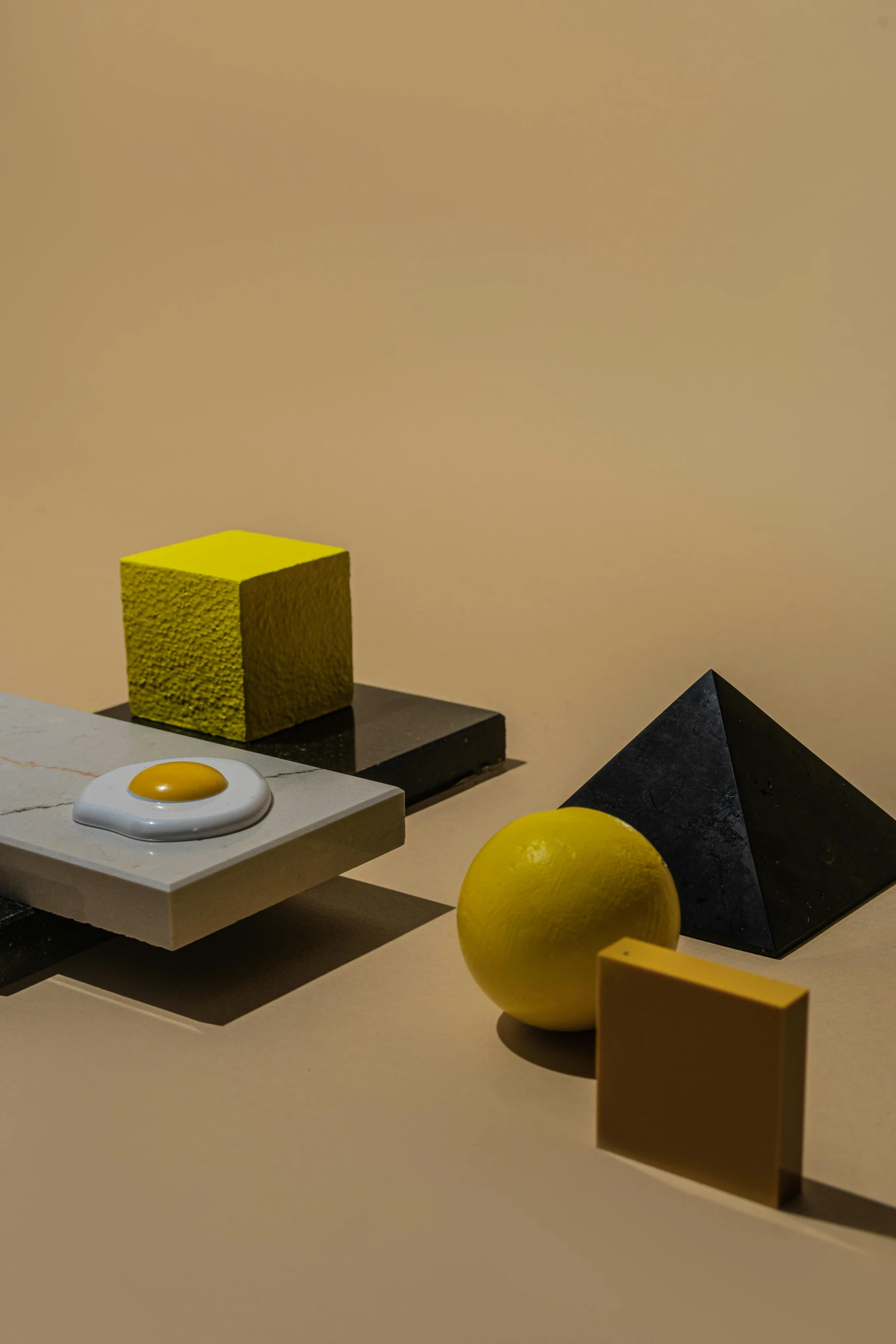 a group of objects sitting on top of a table, inspired by Bauhaus, hypermodernism, yellow charcoal, eggs, square, studio product shot