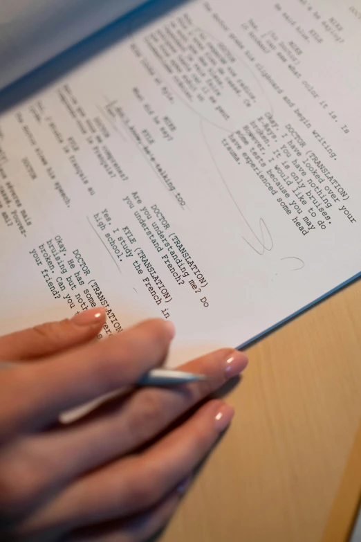 a person holding a pen and writing on a piece of paper, production photo, a list cast, photographed for reuters, back towards camera