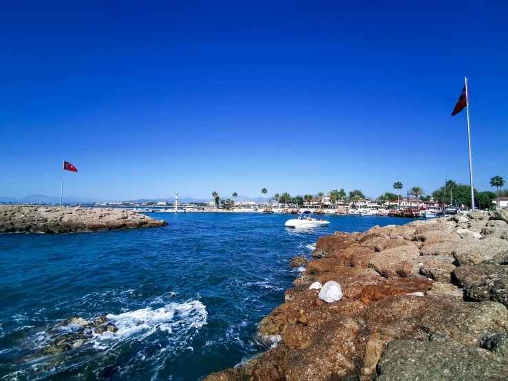 a large body of water next to a rocky shore, pexels contest winner, les nabis, marbella, bored ape yacht club, avatar image