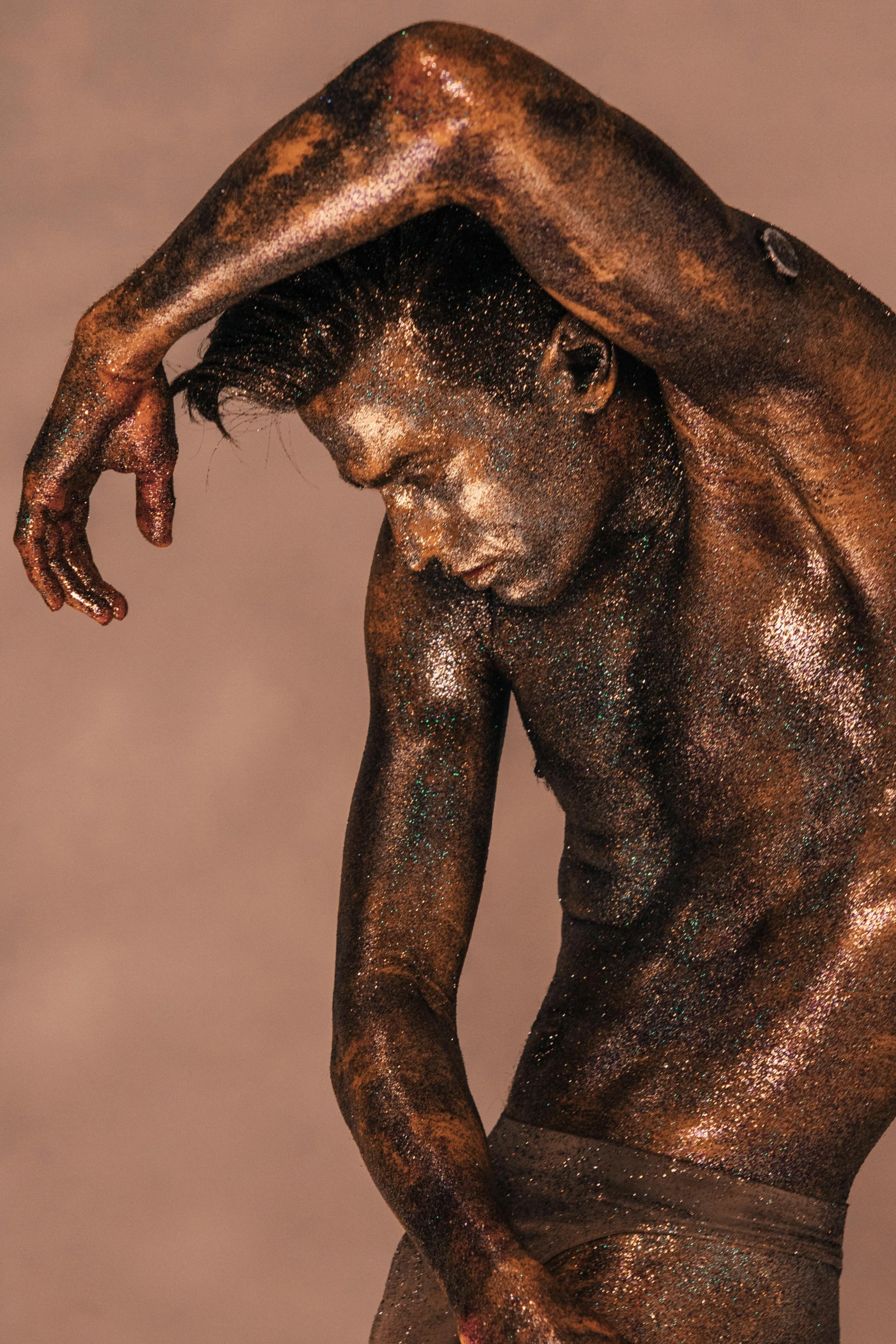 a statue of a man covered in mud, a bronze sculpture, by Julian Allen, featured on zbrush central, dancer, iridescent skin, brown skin, lachlan bailey