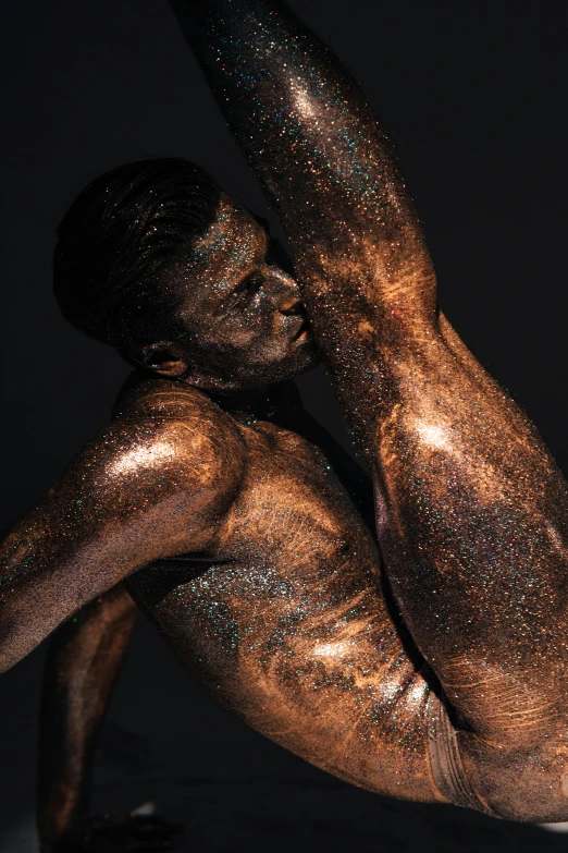 a naked man with gold paint on his body, an album cover, inspired by Hedi Xandt, pexels contest winner, glitter gif, bronze skinned, dark taint :: athletic, light show