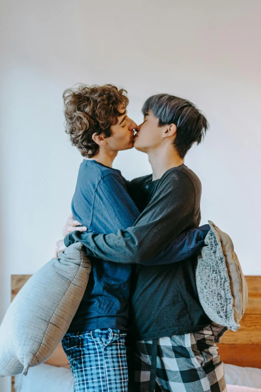 a couple of people that are kissing on a bed, trending on pexels, lesbian embrace, zeen chin and terada katsuya, bench, julian ope