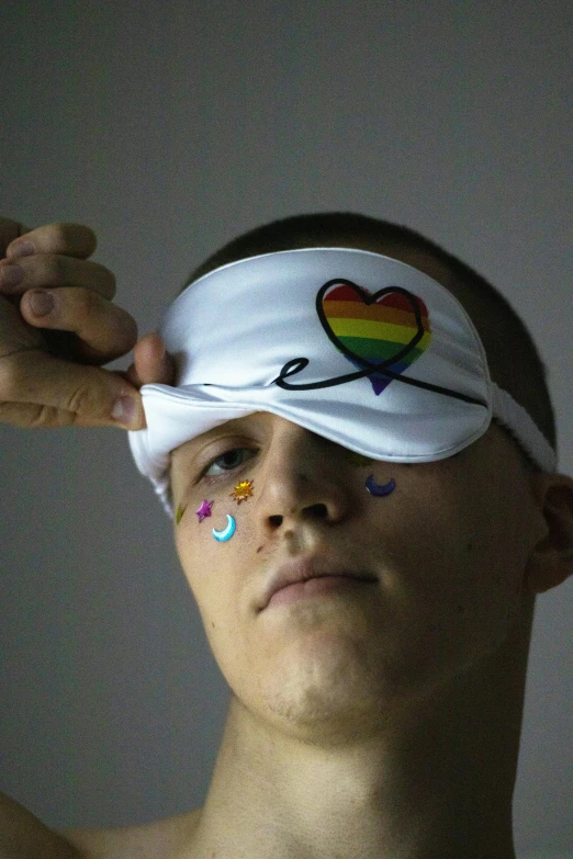 a man with a blindfold covering his eyes, inspired by Okuda Gensō, an epic non - binary model, joe keery, sports photo, heart eyes