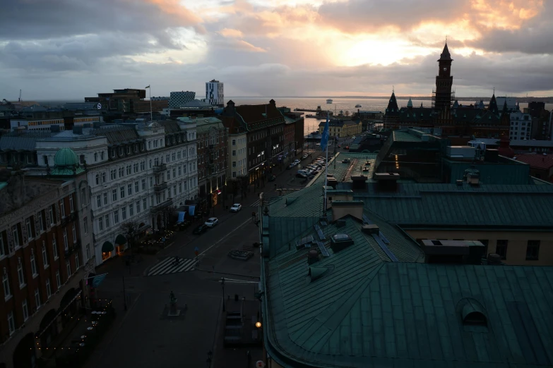 a view of a city from the top of a building, by Christen Dalsgaard, pexels contest winner, hurufiyya, calm evening, sunfaded, seaview, overlooking a dark street