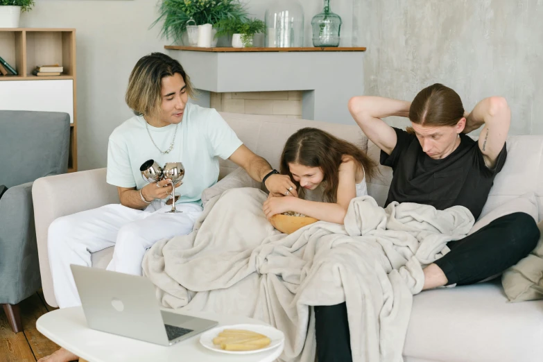 a group of people sitting on top of a couch, trending on pexels, couple on bed, teenage boy, having a snack, cast