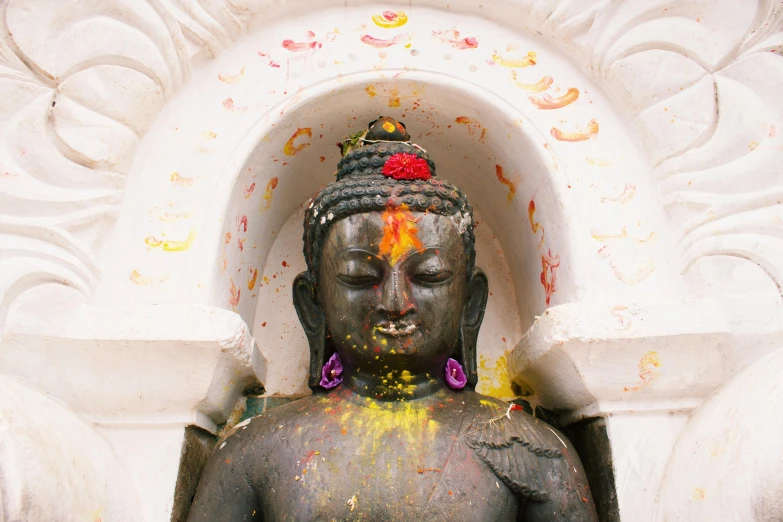 a statue of a person covered in paint, a statue, trending on unsplash, nepal, 🦩🪐🐞👩🏻🦳, acid rains. the sacred nipple, shrines