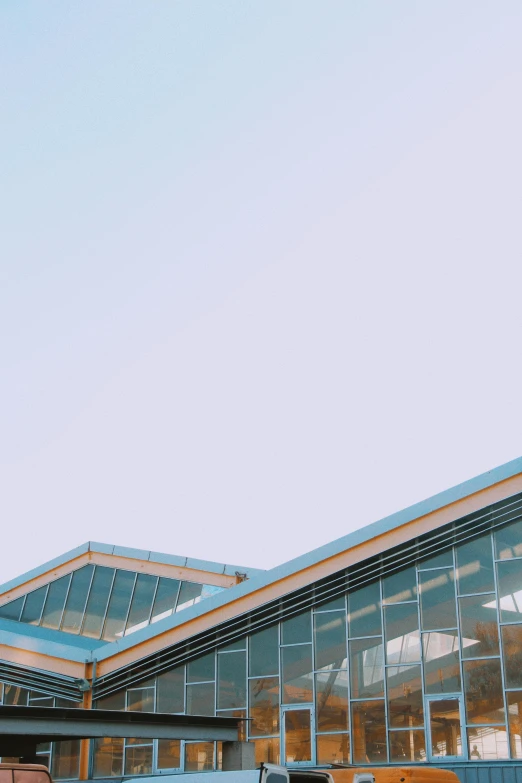 a group of people standing in front of a building, unsplash, modernism, light blue clear sky, roof background, malls, light academia aesthetic