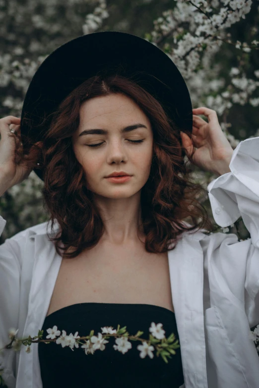 a woman in a white shirt and black hat, inspired by Elsa Bleda, trending on pexels, renaissance, wild ginger hair, thinning hair, attractive photo, curls