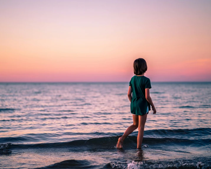 a little girl that is standing in the water, pexels contest winner, minimalism, trailing off into the horizon, early evening, youthful colours, chillwave
