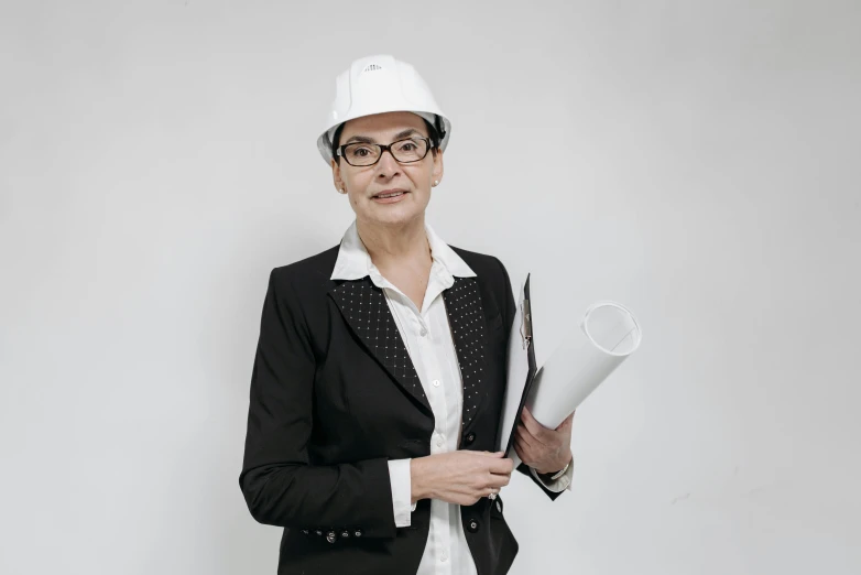 a woman wearing a hard hat and glasses, by Matthias Stom, pexels contest winner, arbeitsrat für kunst, white backround, woman in black business suit, mid - 3 0 s aged, raphael personnaz