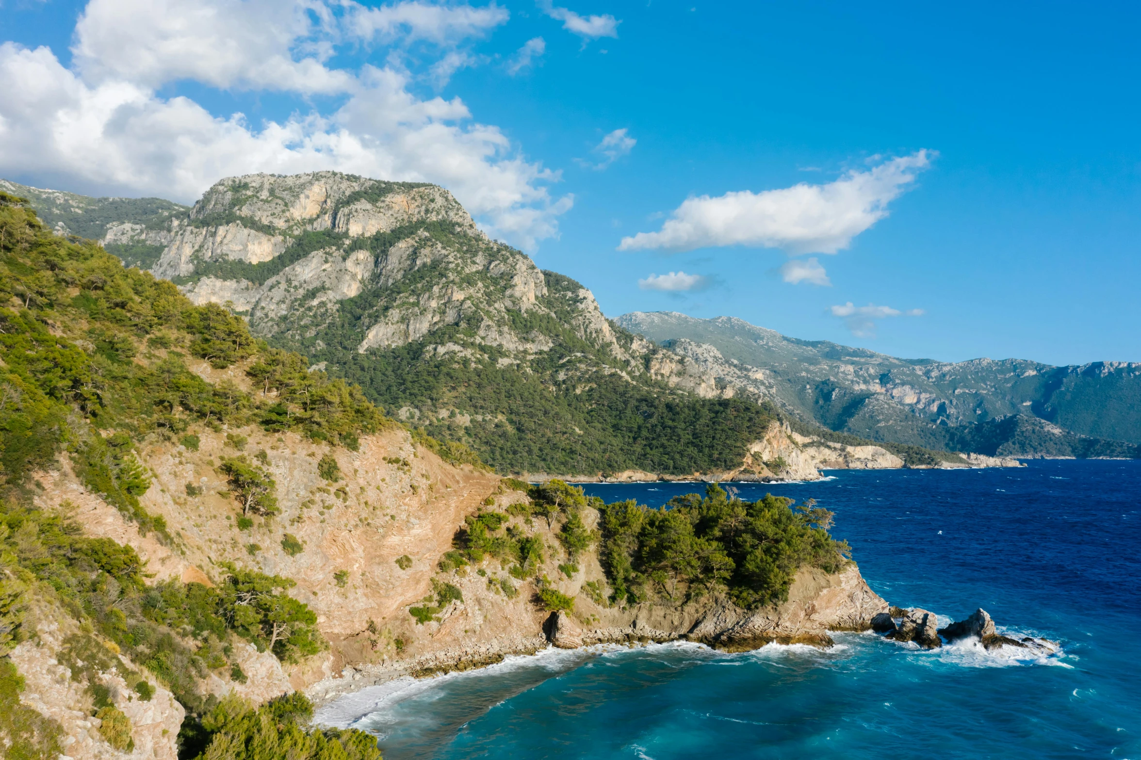 a large body of water next to a lush green hillside, pexels contest winner, les nabis, mediterranean beach background, mount olympus, avatar image, conde nast traveler photo