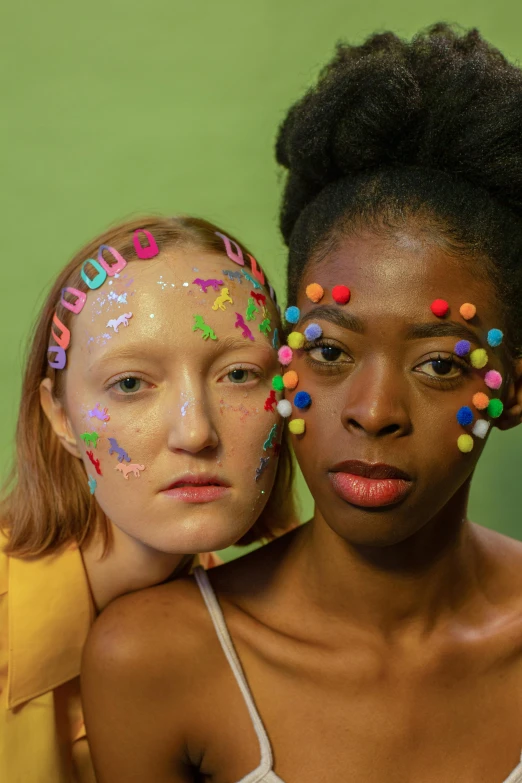two girls with face paint posing for a picture, an album cover, by Lily Delissa Joseph, colored dots, ouchh and and innate studio, with a white complexion, plasticine models