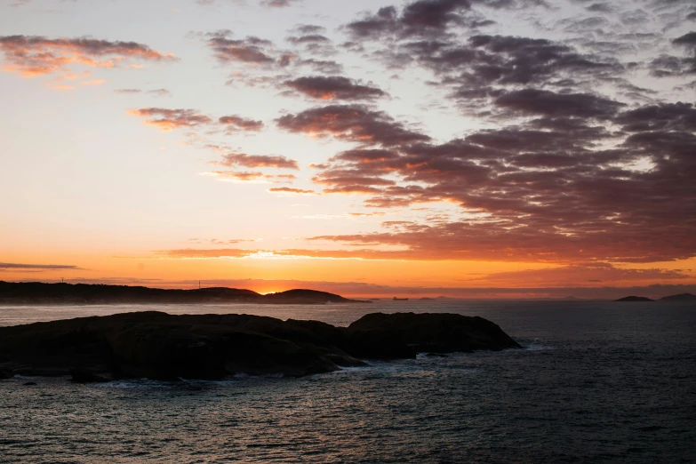 a person flying a kite over a body of water, inspired by Wilhelm Marstrand, pexels contest winner, sunset panorama, archipelago, hestiasula head, overcast dawn