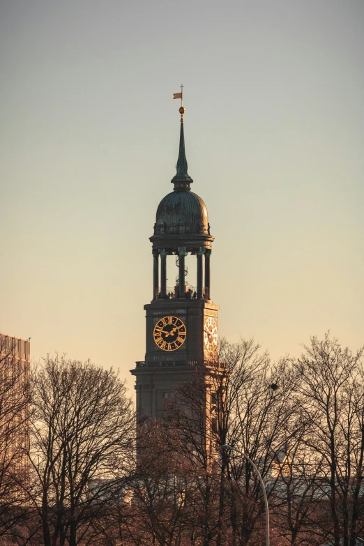 a clock tower in the middle of a city, inspired by Christen Dalsgaard, tonalism, taken at golden hour, boston, winter sun, dome