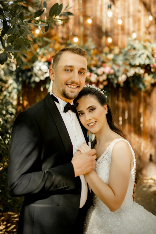 a man in a tuxedo standing next to a woman in a wedding dress, profile image, vines, thumbnail, looking towards the camera