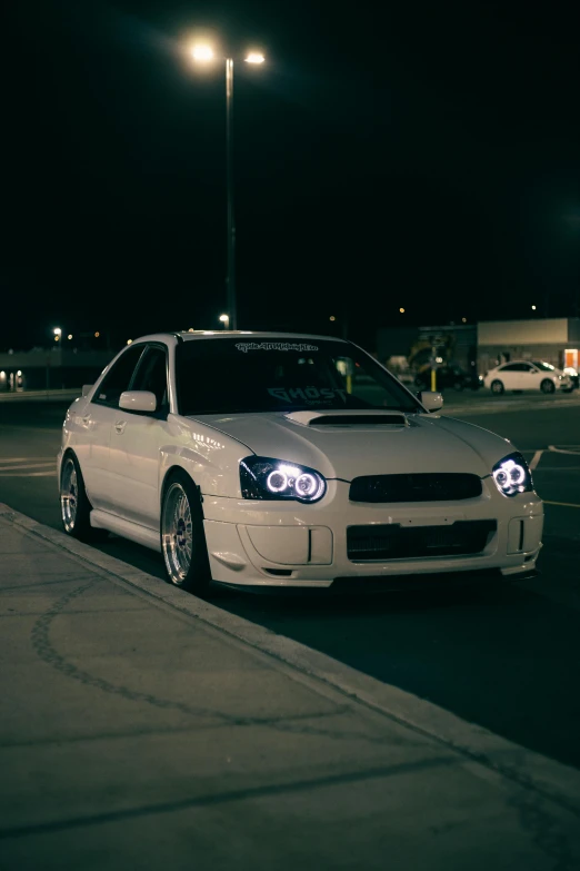 a white car parked in a parking lot at night, inspired by An Gyeon, reddit, subaru, strong rim light!!!!!, 2 0 0 0's photo, portrait of jerma985