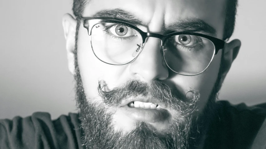 a close up of a man with glasses and a beard, pexels, hyperrealism, scary angry pose, square rimmed glasses, music video, hyperrealistic!