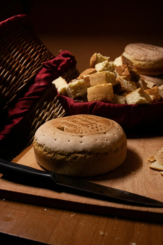 a basket of bread sitting on top of a wooden table, by Romano Vio, romanesque, made of swiss cheese wheels, ready to eat, carving, full product shot