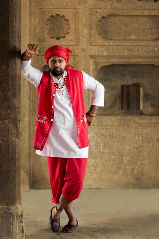 a man in a red turban poses for a picture, an album cover, inspired by Sardar Sobha Singh, pexels contest winner, dau-al-set, white waistcoat, full body photgraph, ( ( theatrical ) ), square