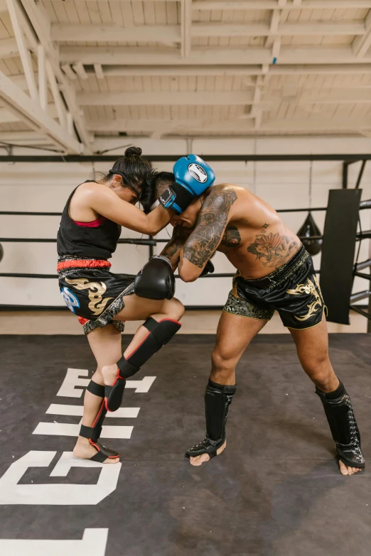 a couple of men standing next to each other in a boxing ring, by Natasha Tan, trending on unsplash, heroic muay thai stance pose, knee pads, square, maori