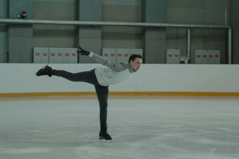 a man riding a skateboard on top of an ice rink, inspired by Daniël Mijtens, arabesque, **cinematic, pointe pose, video still, lachlan bailey