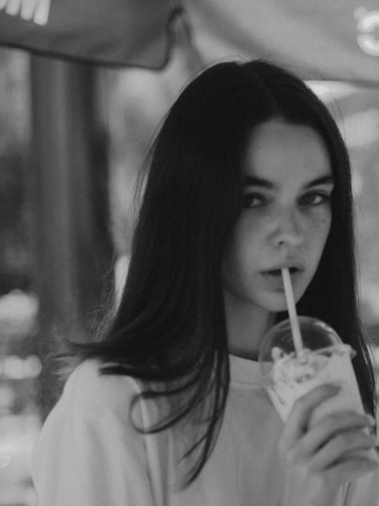 a black and white photo of a woman drinking a drink, tumblr, hailee steinfeld, anna nikonova aka newmilky, 🌺 cgsociety, pale snow white skin