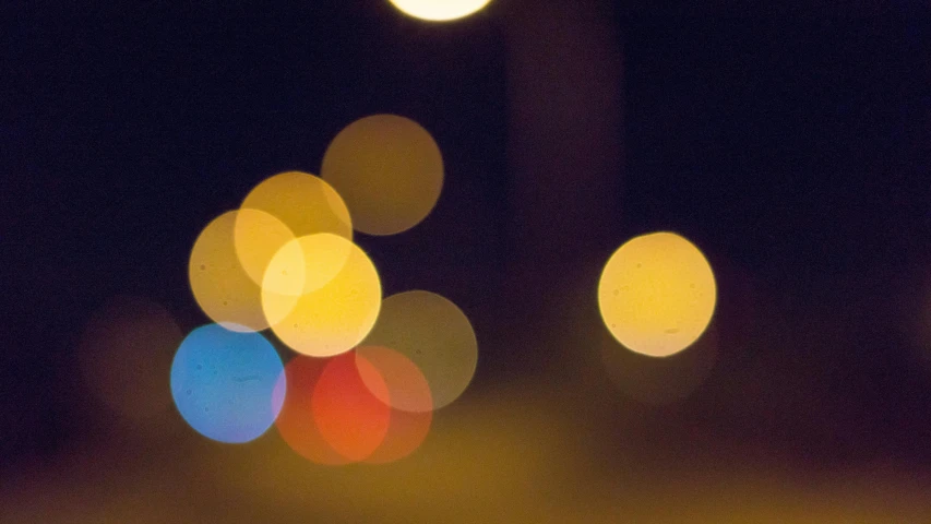 a blurry photo of a street at night, by Jan Rustem, pexels, lyrical abstraction, close - up bokeh, light circles, soft light - n 9, multicoloured