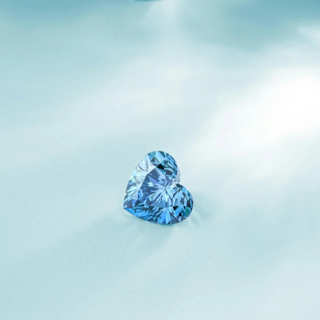 a blue diamond sitting on top of a white surface, by Matija Jama, trending on pexels, hearts, shot with sony alpha, beautifully daylight, switzerland