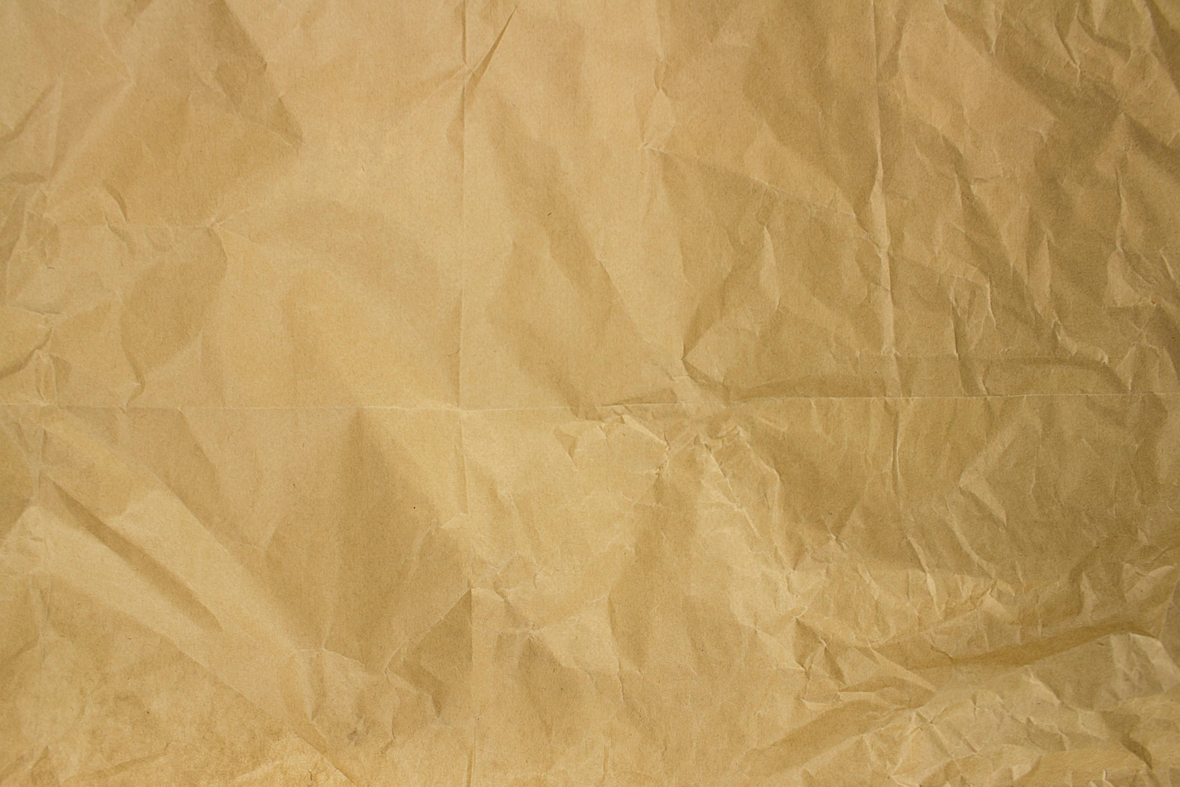 a close up of a piece of paper on a table, beige background, background image, tissue paper art, detailed product image