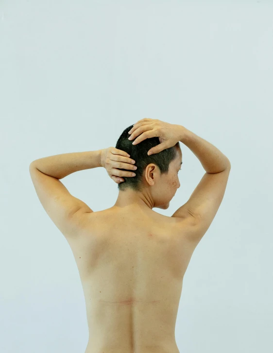 a woman that is standing up with her back to the camera, inspired by Ren Hang, unsplash, massurrealism, short hair with gel, profile image, scars, nonbinary model