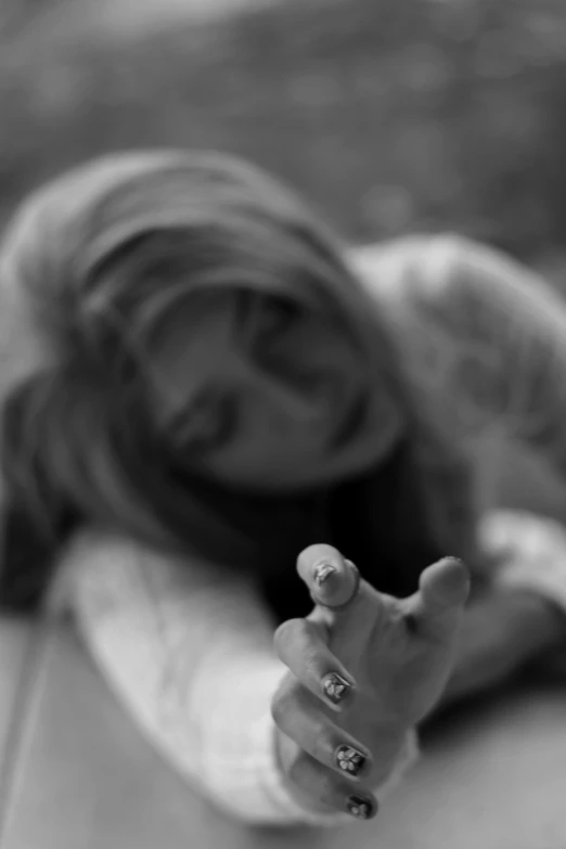 a black and white photo of a woman on a surfboard, a black and white photo, inspired by Kurt Roesch, flickr, photo of a hand jewellery model, blurred, heartbroken, laying on the ground