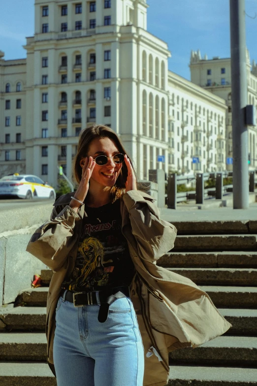 a woman talking on a cell phone in front of a building, style of julia razumova, instagram picture, wearing casual clothing, soviet style