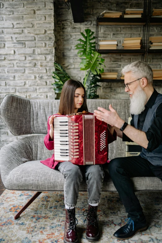 a man and a woman sitting on a couch playing an accordion, pexels contest winner, daughter, old gigachad with grey beard, kid, architect