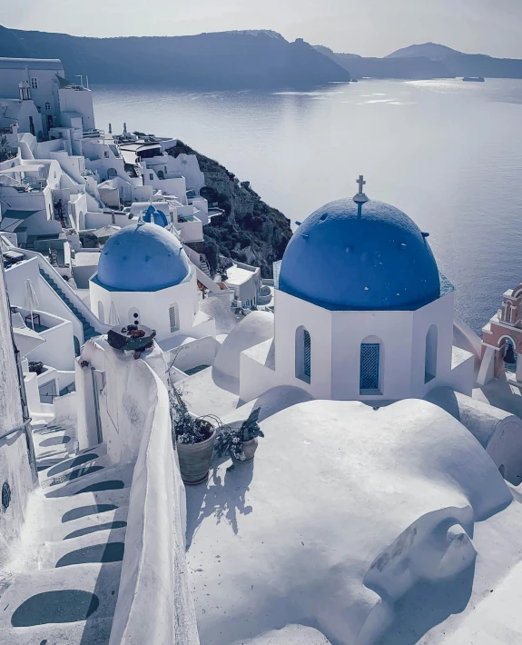 a blue dome sitting on top of a white building next to a body of water, whitewashed buildings, behance lemanoosh, slide show, lgbtq