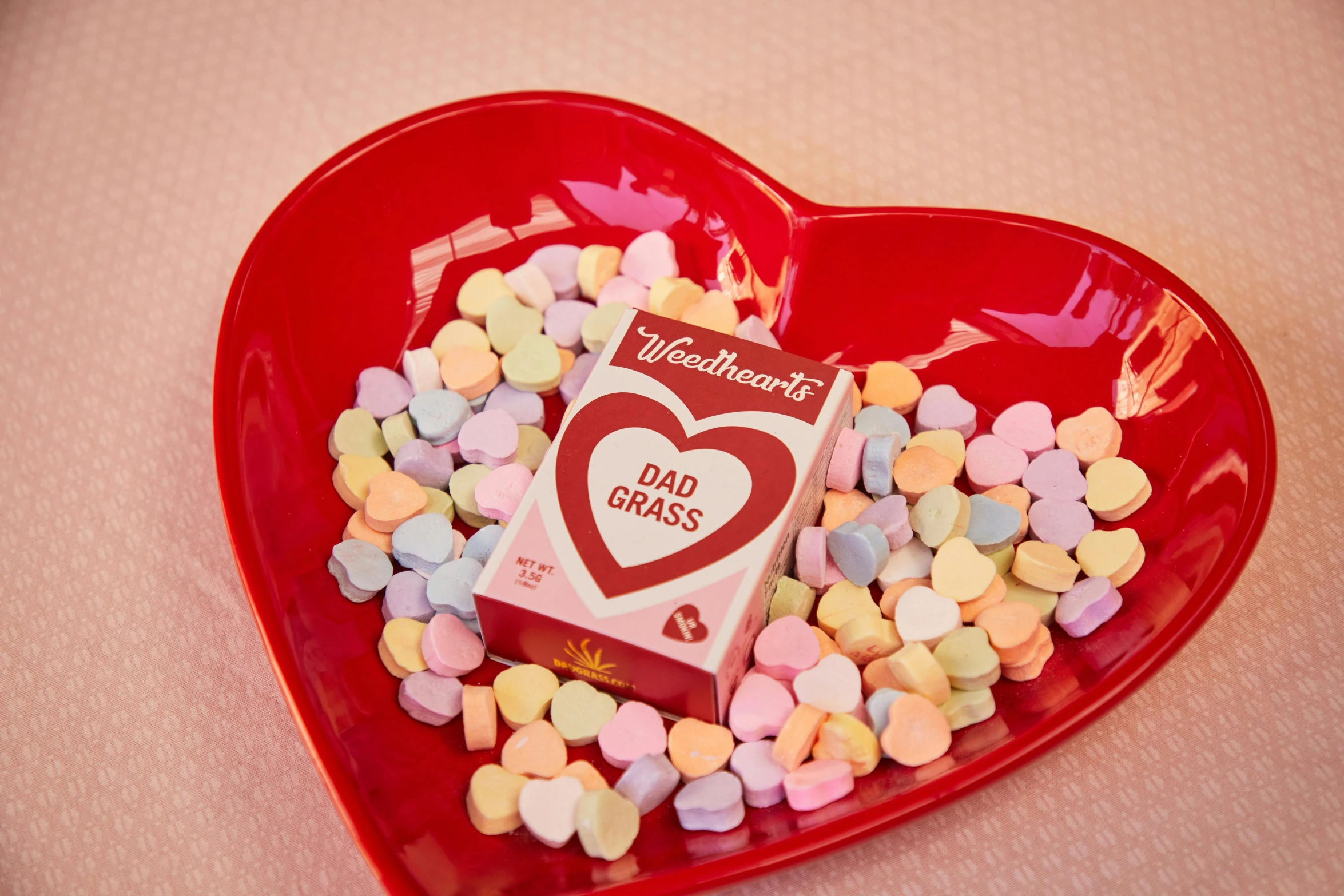 a heart shaped bowl filled with candy and marshmallows, a cartoon, inspired by Peter Alexander Hay, dad, card game, worn, frank moth