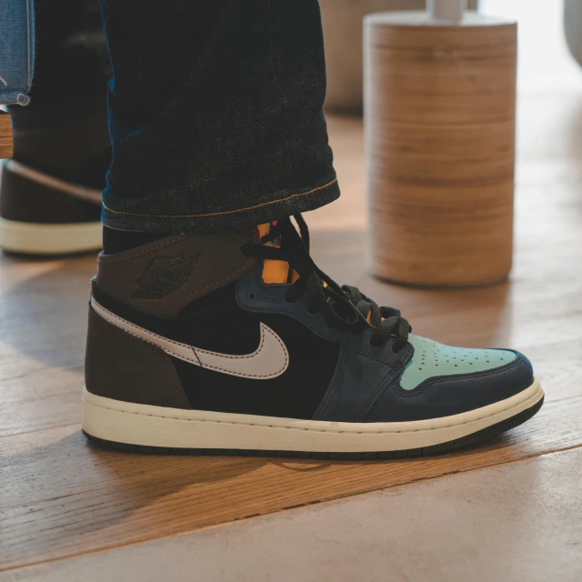 a pair of sneakers sitting on top of a wooden floor, an album cover, unsplash, hurufiyya, air jordan 1 high, black blue green, full - body - front - shot, muted colors. ue 5