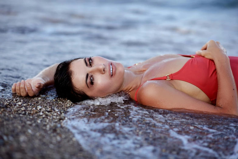 a woman in a red bikini laying on the beach, a portrait, unsplash, sasha grey, nina dobrev, avatar image, uncropped