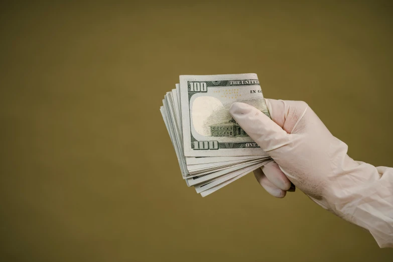 a person in a glove holding a stack of money, by Daniel Lieske, pexels contest winner, renaissance, nurse, 15081959 21121991 01012000 4k, instagram post, high transparency