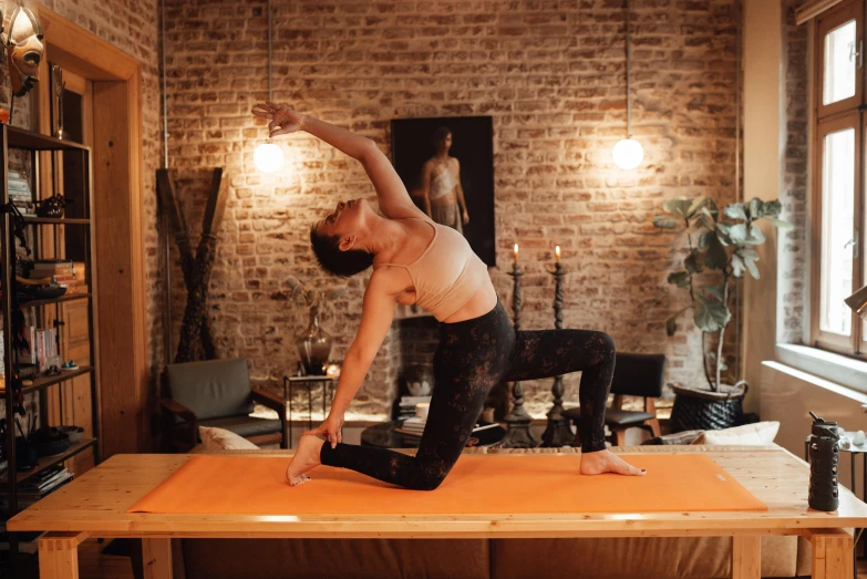 a woman doing a yoga pose in a living room, a picture, unsplash, arabesque, back arched, low quality photo, sacral chakra, glossy surface