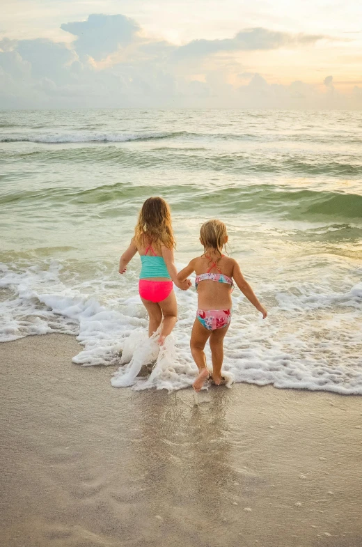 two little girls playing in the water at the beach, by Greg Spalenka, walking to the right, travel, 8 k -, slide show