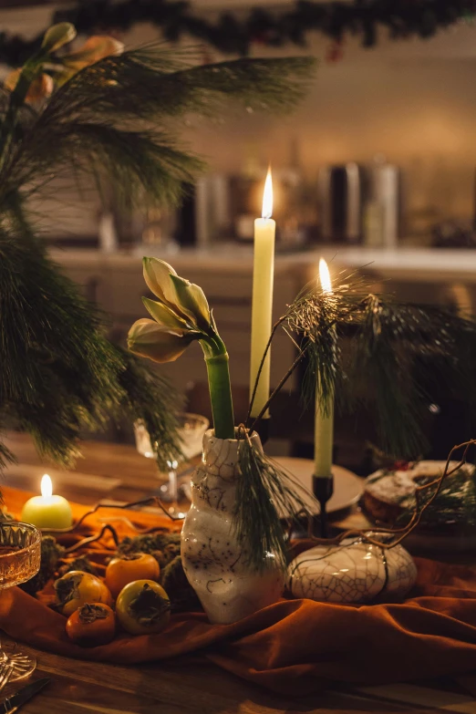 a table that has a bunch of candles on it, holiday vibe, profile image, magic hour lighting, evergreen branches