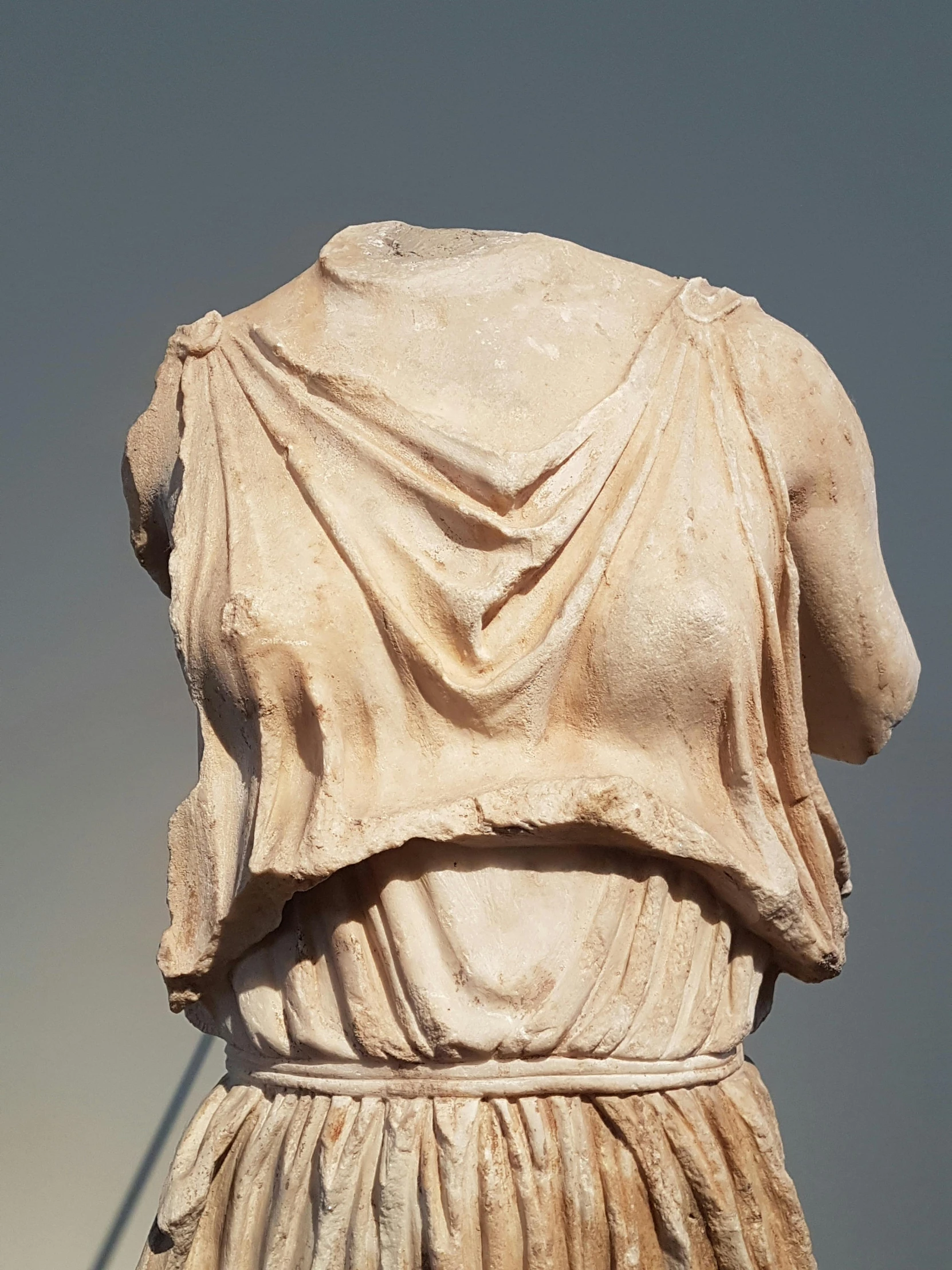 a close up of a statue of a woman, showing her shoulder from back, realistically rendered clothing, headless, doric