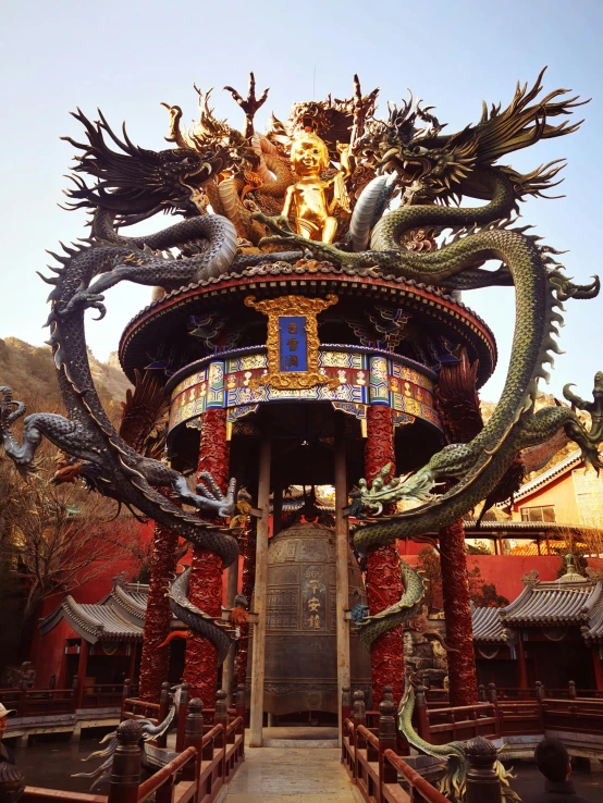 a building with a dragon statue on top of it, a statue, by Han Gan, dmt temple, avatar image