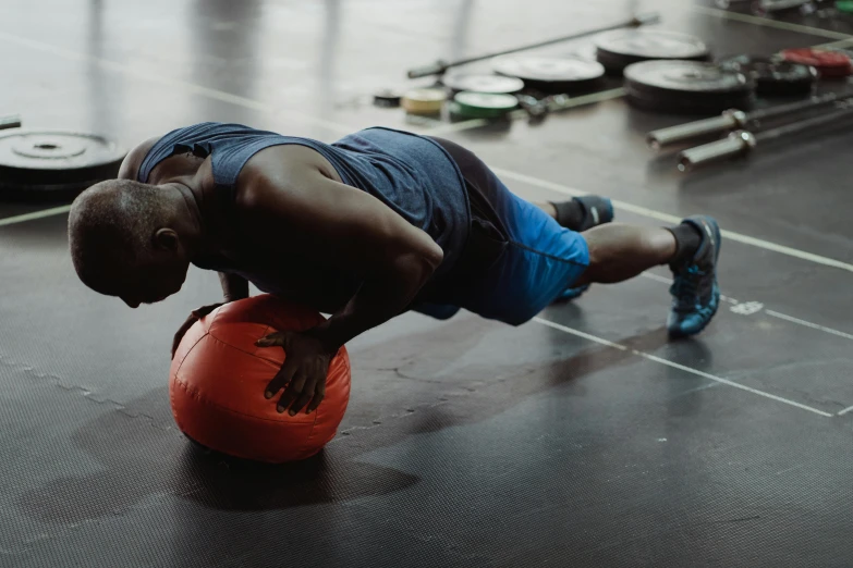 a man doing push ups on a ball in a gym, pexels contest winner, jaylen brown, origin jumpworks, profile image, background image