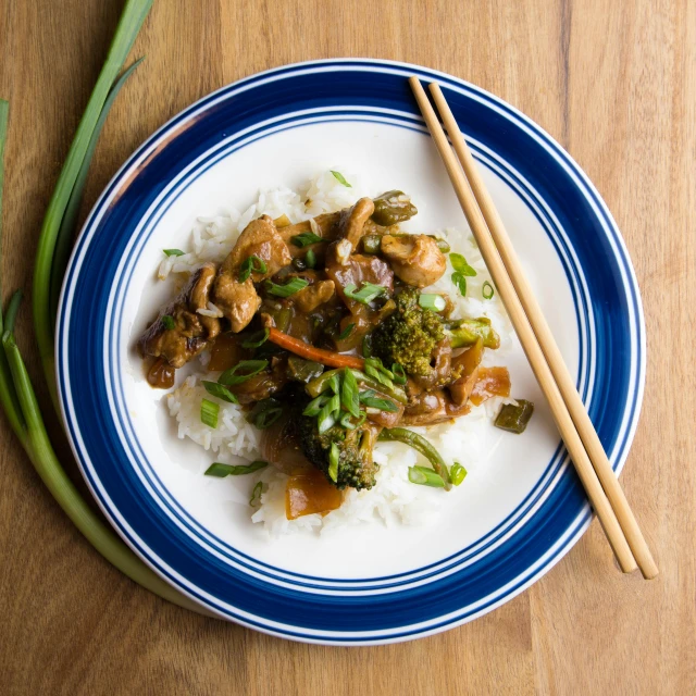 a close up of a plate of food with chopsticks, fan favorite, brown, yee chong silverfox, product shot