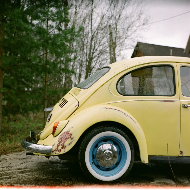 a yellow vw bug parked in front of a house, an album cover, inspired by Elsa Bleda, pexels contest winner, photorealism, portrait of a slightly rusty, expired film analog photography, a wooden