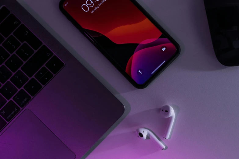 a laptop computer sitting on top of a desk next to an apple airpods, trending on pexels, minimalism, purple accent lighting, gradient red to black, phone wallpaper, detailed product image